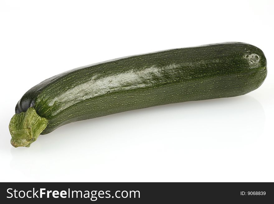 A single courgette or zucchini on white. A single courgette or zucchini on white
