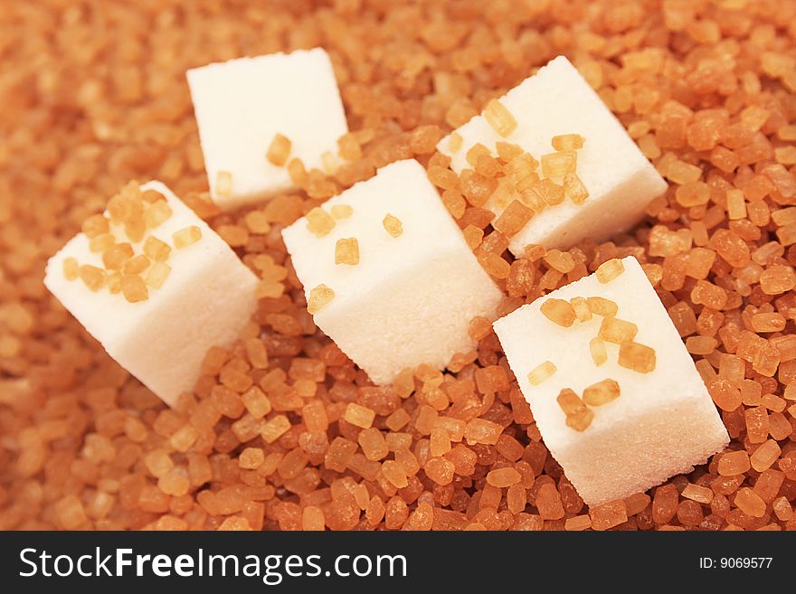 White sugar cubes and brown sugar. White sugar cubes and brown sugar.