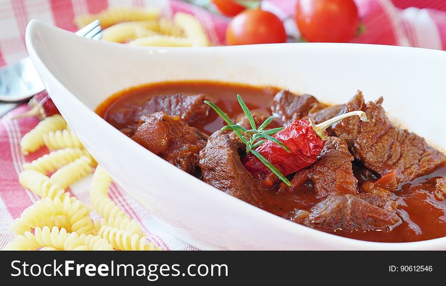 A bowl of beef stew with chili. A bowl of beef stew with chili.