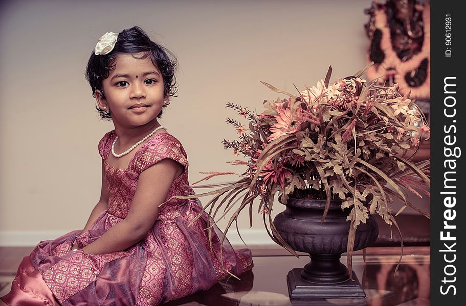 Girl Beside Flower Vase Inside White Painted Room