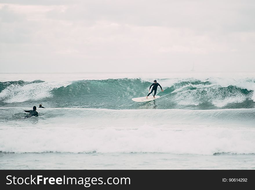 Surfers On Waves