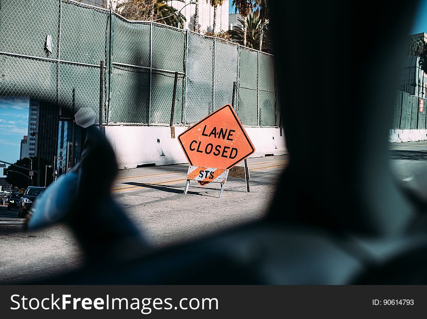 Lane closed construction sign viewed from motor car interior.