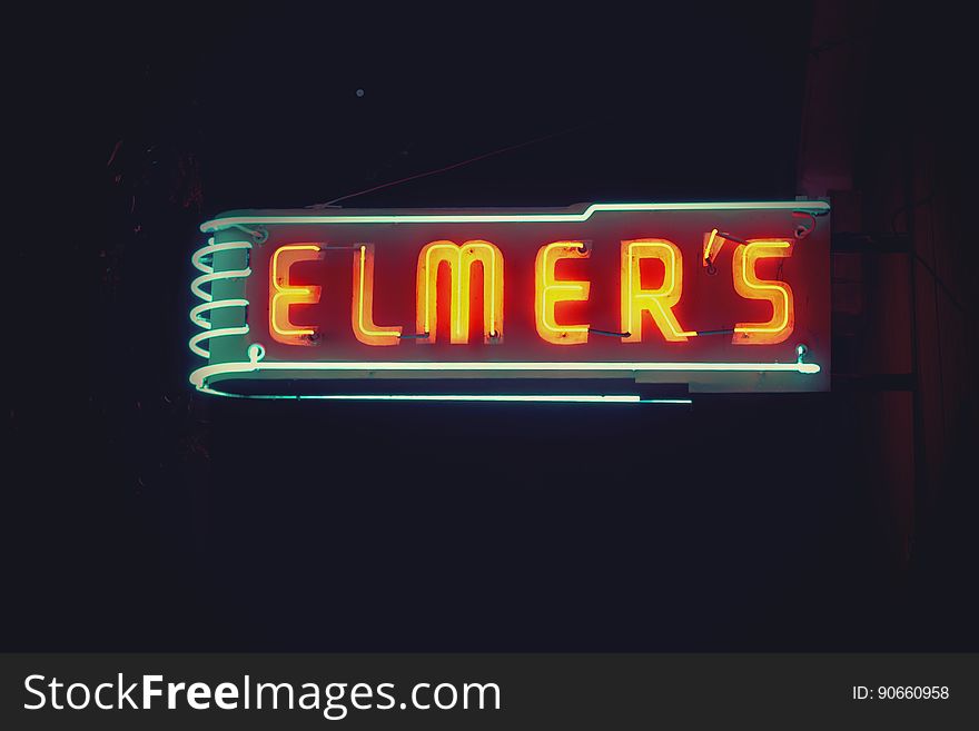 A bar or a diner with a neon sign in the night.