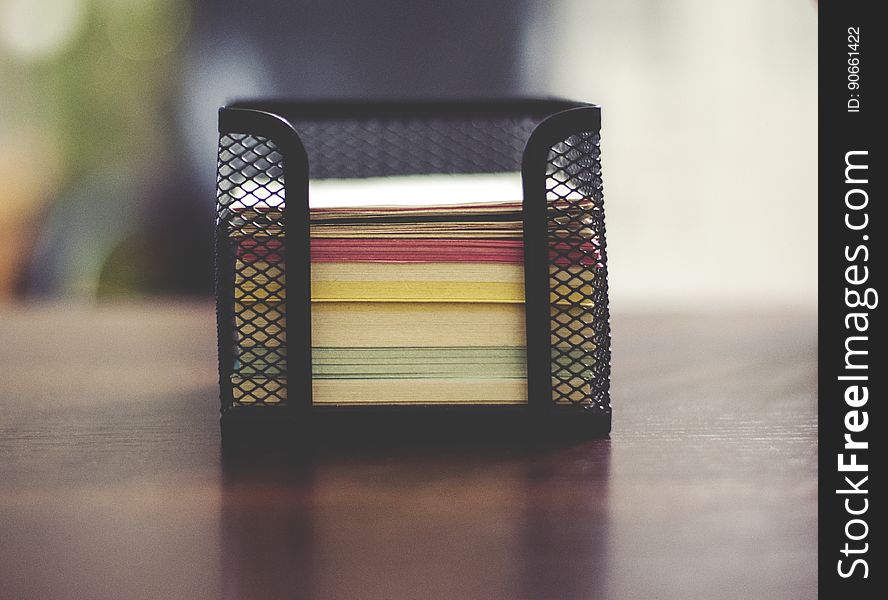 Close up of metal container with colorful sheets of notepaper. Close up of metal container with colorful sheets of notepaper.