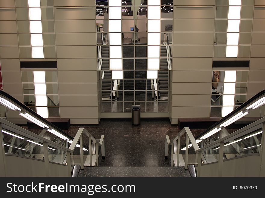 Escalators and stairway mirrored in a modern building