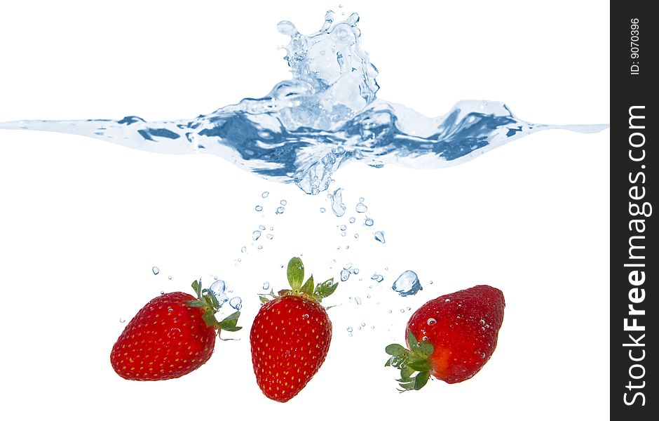 Three Strawberries Falling Into The Water