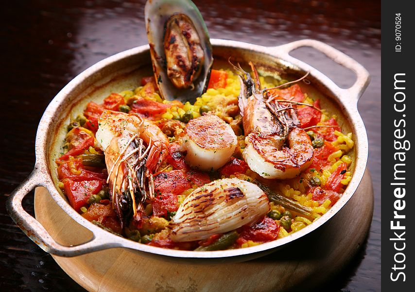 Pilau with sea by products in a steel dish. Pilau with sea by products in a steel dish.