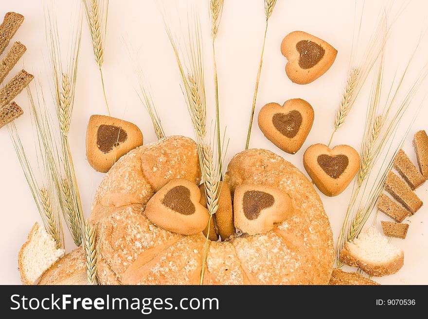 Baked goods with wheat on the background