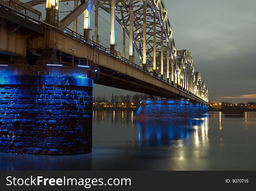 Illuminated Riga Railway bridge over river Daugava at night