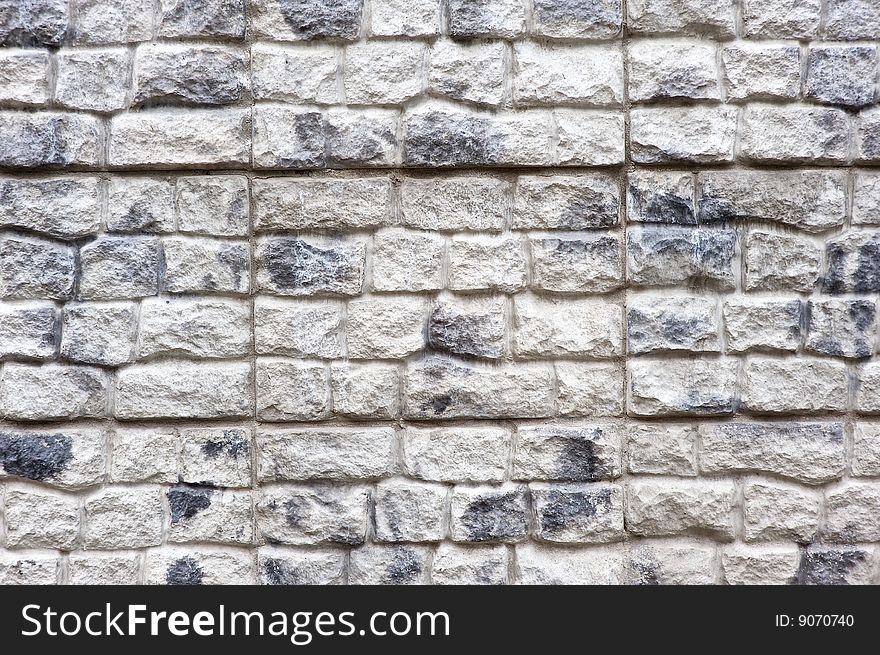 Grey old brick wall of building