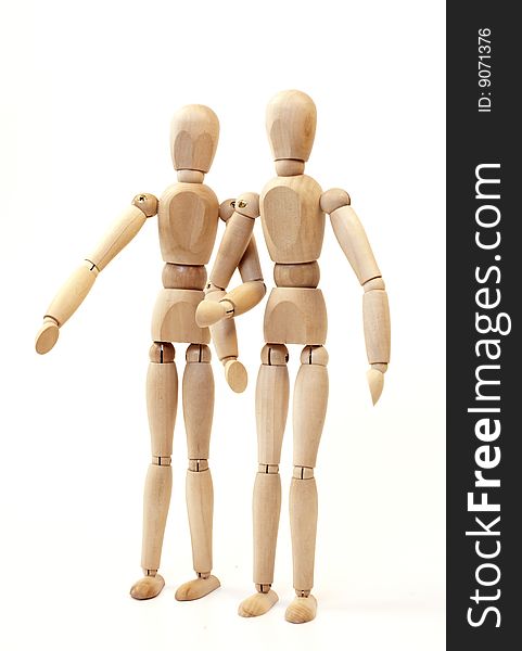 Wooden figures stand side by side, isolated on a white background. Wooden figures stand side by side, isolated on a white background