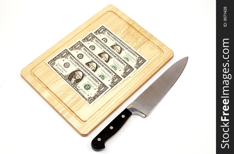 America money on a chopping board with a knife on a white background