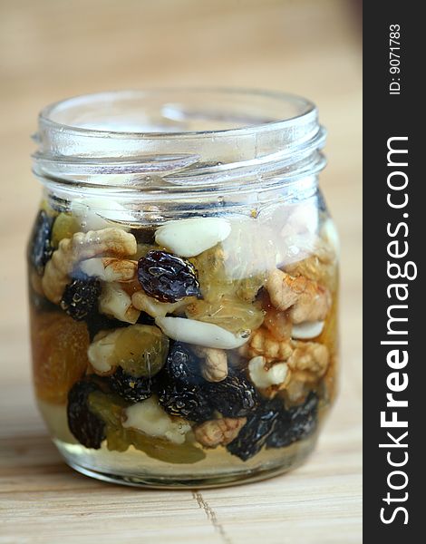 Can with bee honey with walnuts and dried fruits