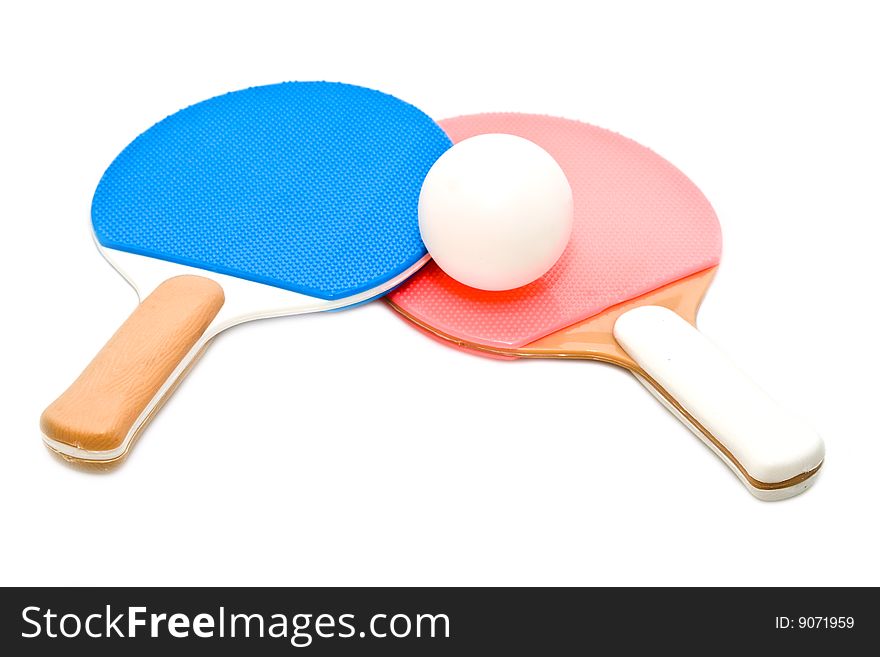 Two rackets and ball on a white background