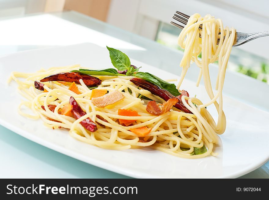 Spaghetti fried with chilly and bacon. Spaghetti fried with chilly and bacon