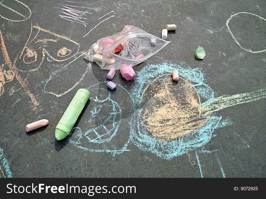 Sidewalk chalk art created with chunks of chalk from a plastic bag