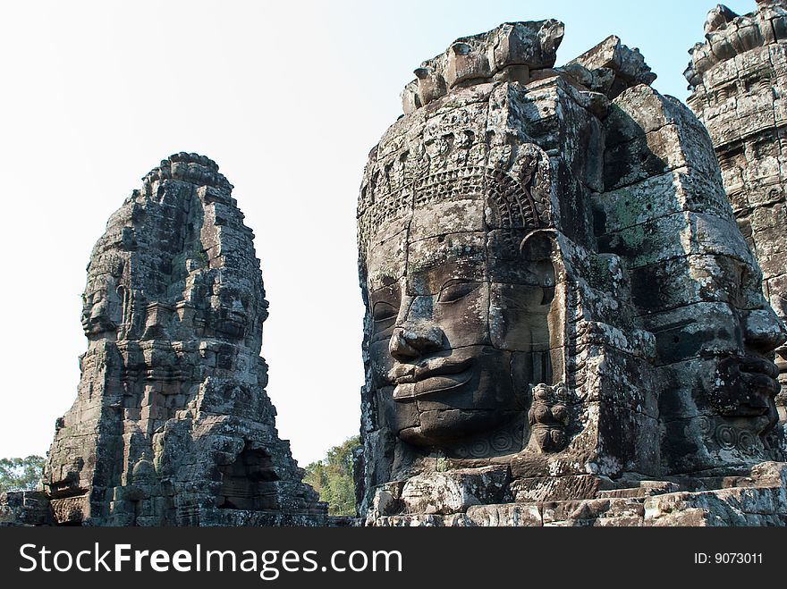 Stone faces on towers of Bayon temple in Angkor Thom, Cambodia. Stone faces on towers of Bayon temple in Angkor Thom, Cambodia