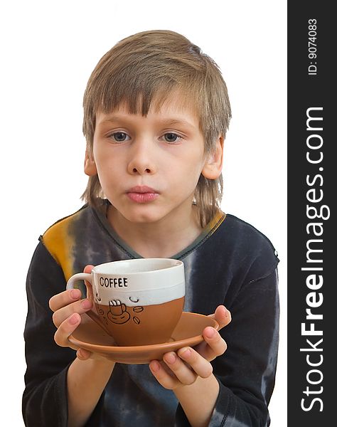 Young boy blow to a cup of coffee in his hand. Young boy blow to a cup of coffee in his hand