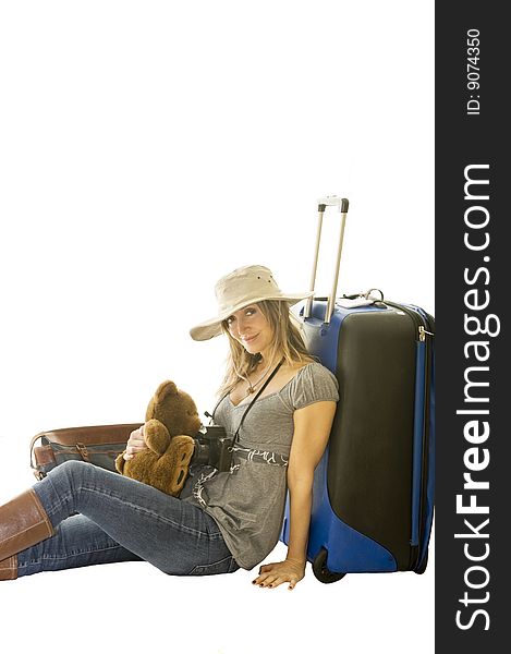Happy woman going on vacation with passport and her suitcase over a white background