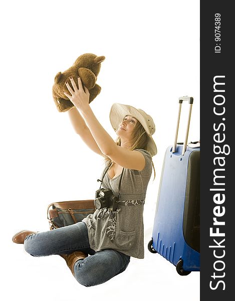 Happy woman going on vacation with passport and her suitcase over a white background