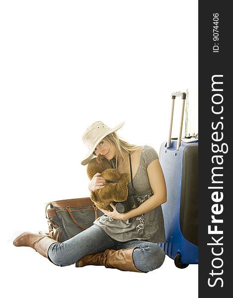 Happy woman going on vacation with passport and her suitcase over a white background