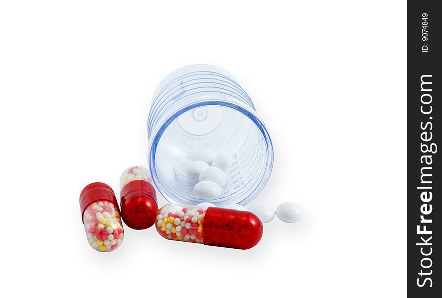 Tablets and pilbli in a plastic beaker on a white background, isolated