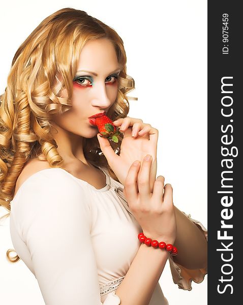 Portrait of pretty blonde with fresh strawberry