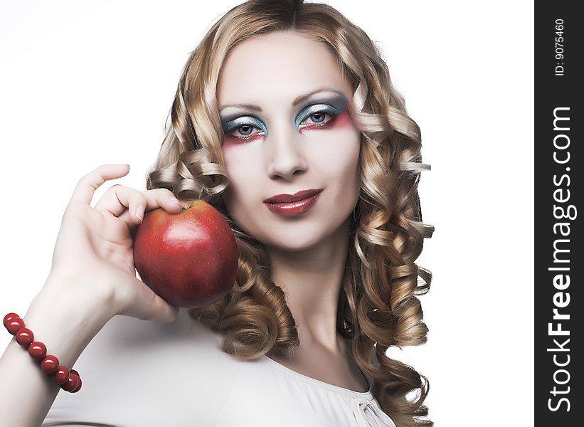 Portrait of pretty blonde with red apple