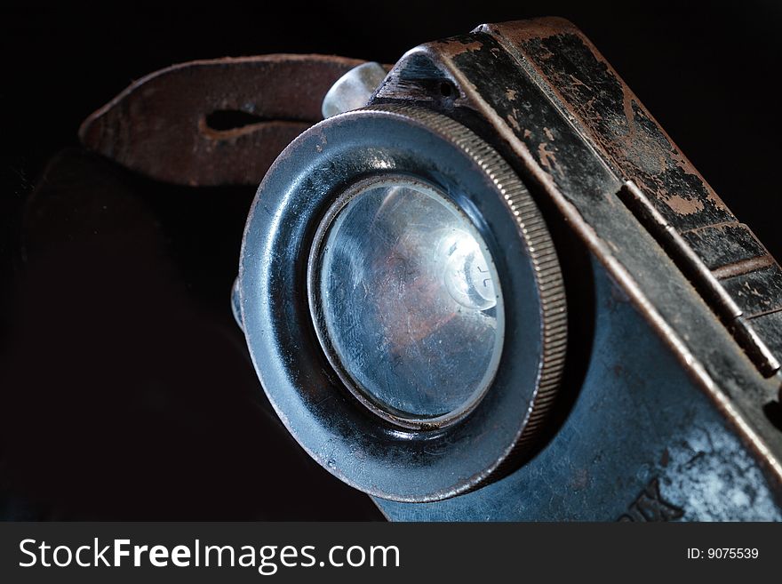 Close-up of old rusty pocket flashlight on dark background. Close-up of old rusty pocket flashlight on dark background