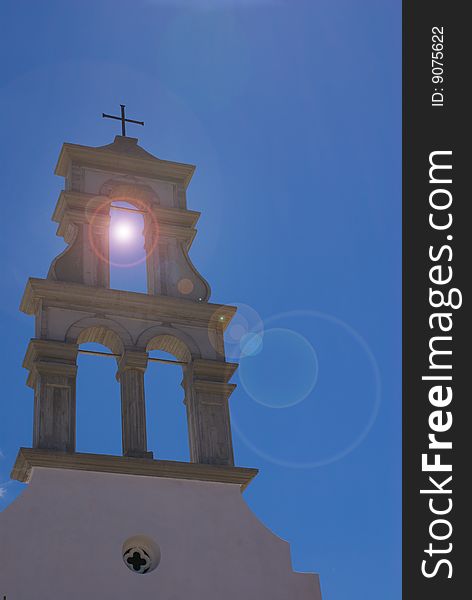 Church steeple in Crete with sun behind it. Good result with lens flare as well