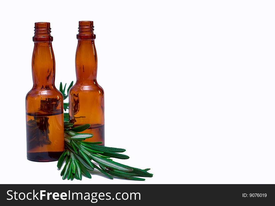 Oil for the body with a sprig of rosemary