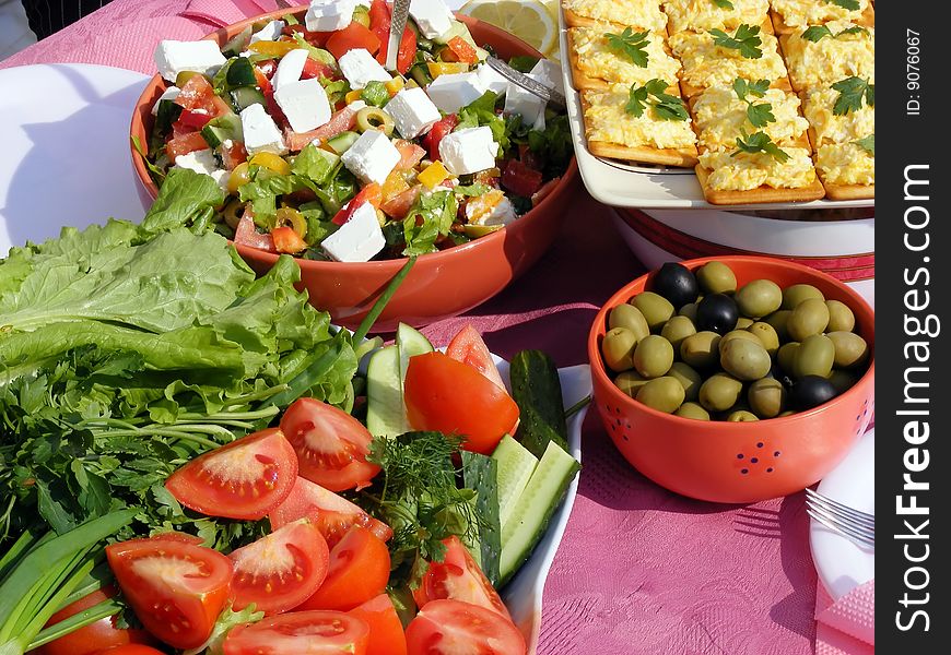 Still life of fresh vegetables - tomatoes, sandwich, cucumbers, onions on the table. Still life of fresh vegetables - tomatoes, sandwich, cucumbers, onions on the table