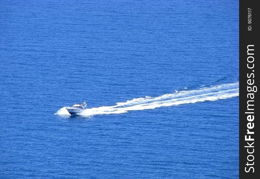 Naval motorboat floats on the high seas clear sunny day