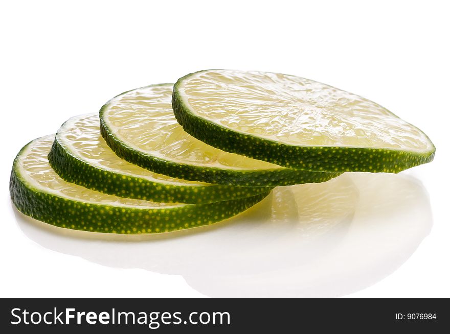 A horizontal close-up of juicy fresh cut lime slices.