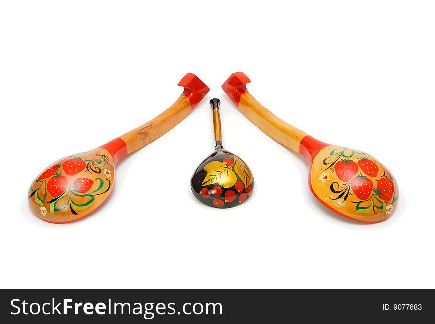 Three wooden Russian hand-painted spoons on white background. Three wooden Russian hand-painted spoons on white background