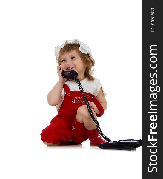 Little girl speaks on the phone. Studio shot. Little girl speaks on the phone. Studio shot