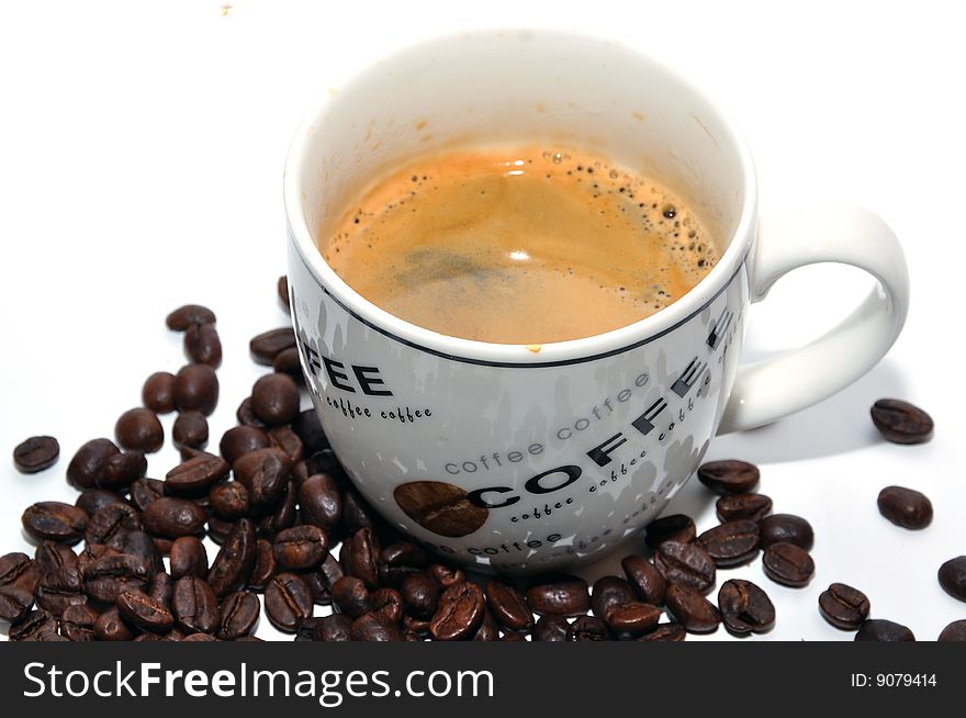 Cup of espresso and coffee beans on a white background. Cup of espresso and coffee beans on a white background