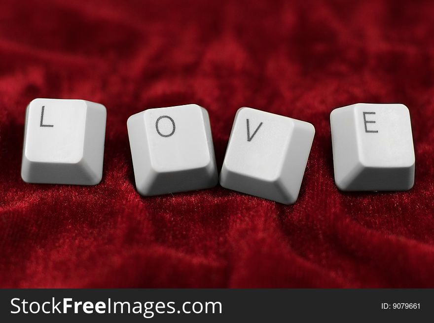 Deep love: keyboard LOVE caption on red cloth
