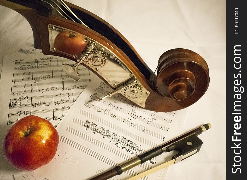 Red Apple Fruit on Music Sheet