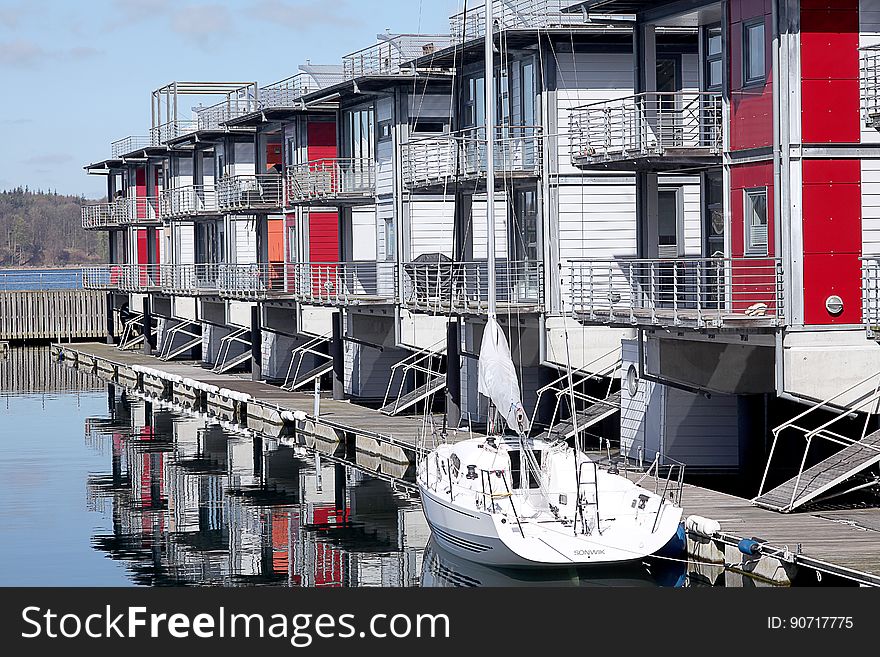 Boat On Pier With Boathouses