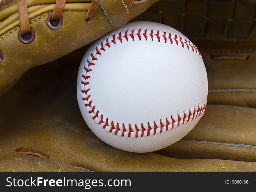 New baseball in an old glove. New baseball in an old glove.