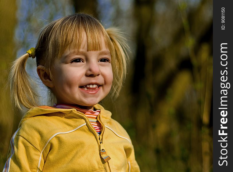 The little girl in spring park looks at a sunset. The little girl in spring park looks at a sunset