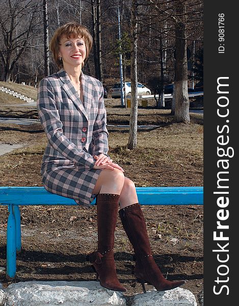 Stylish Young Woman Sit On The Bench.