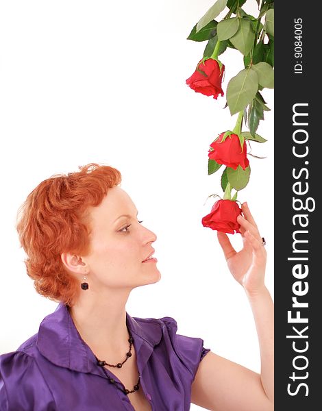 Nice red-hair woman with fresh red roses over white. Nice red-hair woman with fresh red roses over white