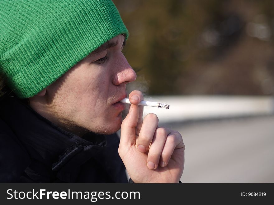 Portrait young men smoking a cigarette. Portrait young men smoking a cigarette