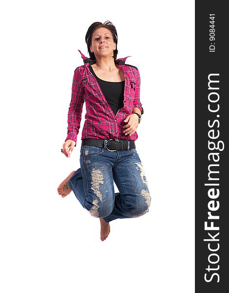 Portrait of a young woman wearing a pink shirt and ripped blue jeans. She is jumping in the air. Slight motion bluriness is intended. Portrait of a young woman wearing a pink shirt and ripped blue jeans. She is jumping in the air. Slight motion bluriness is intended.