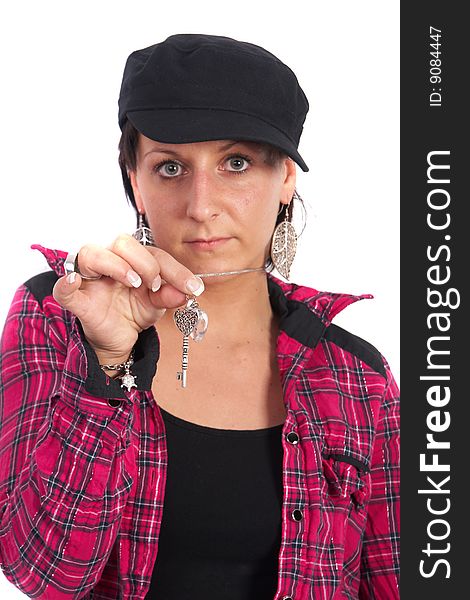 Portrait of a young woman wearing a pink shirt and ripped blue jeans. She is showing a key. Focus is on the key. Portrait of a young woman wearing a pink shirt and ripped blue jeans. She is showing a key. Focus is on the key.