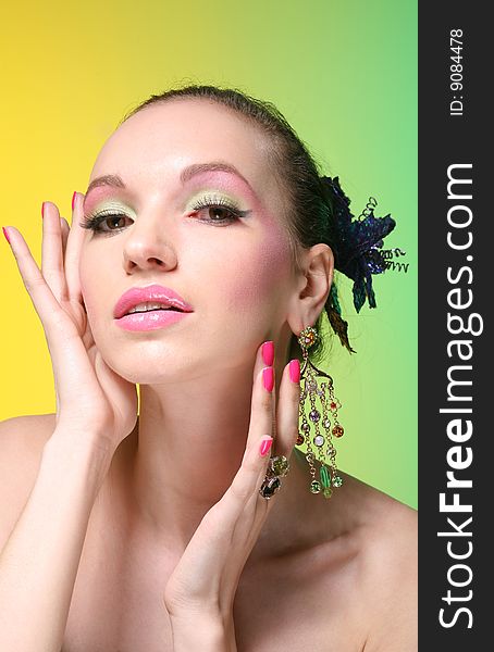 Beautiful girl with make up on yellow-green background