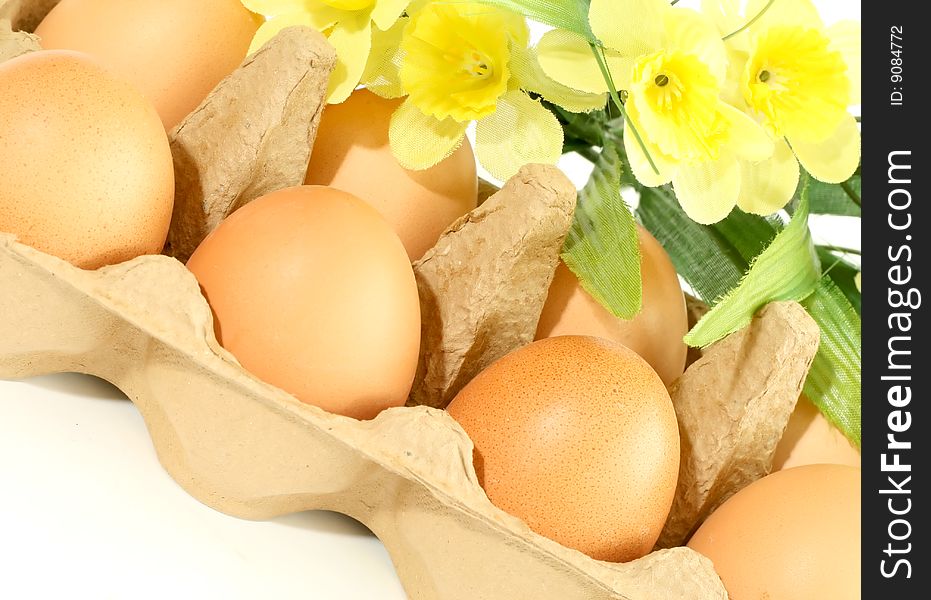 Eggs In Box With Flowers Isolated On White