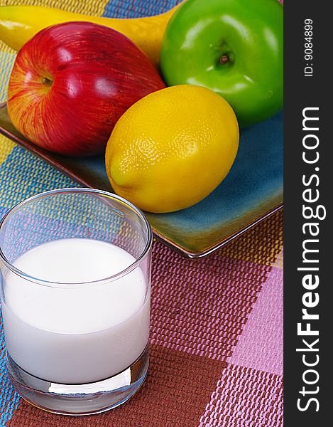 Fruits and milk in a colorful background